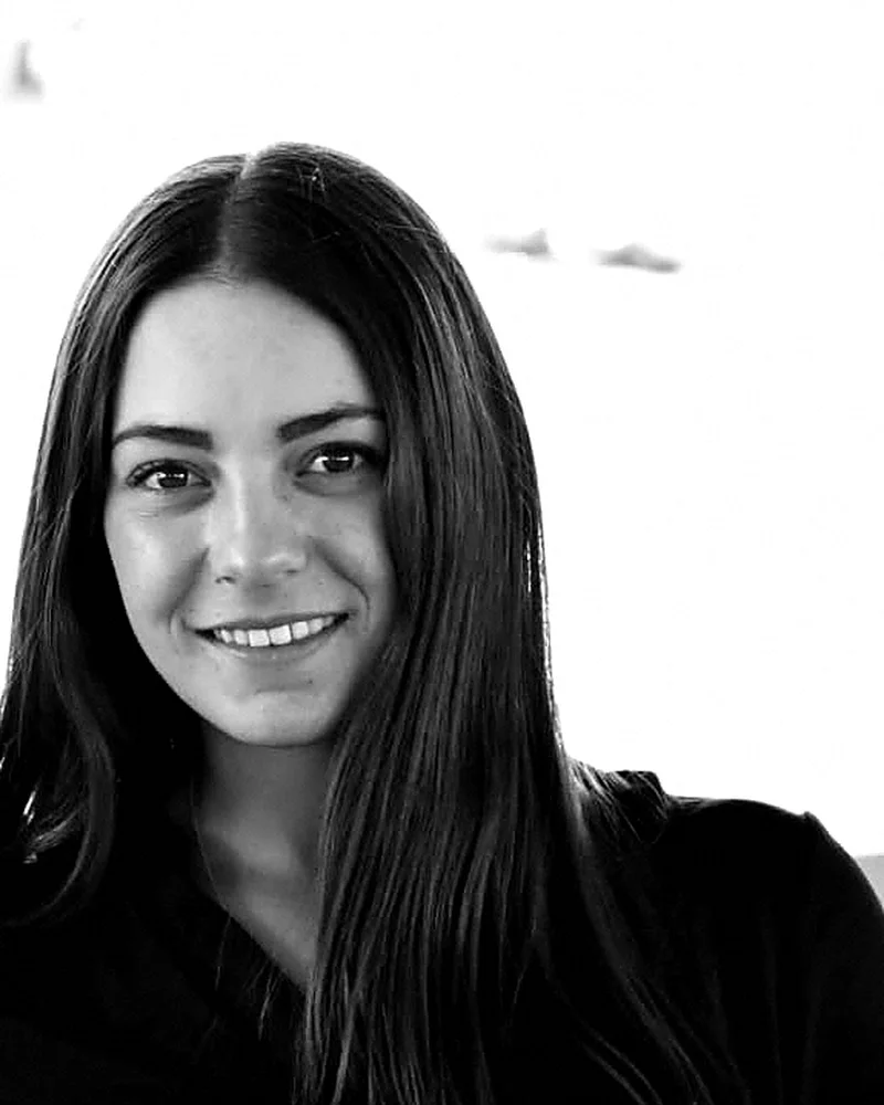 Constanza Duarte, founder of Casa Aurea — black-and-white editorial portrait in a thin gold frame.